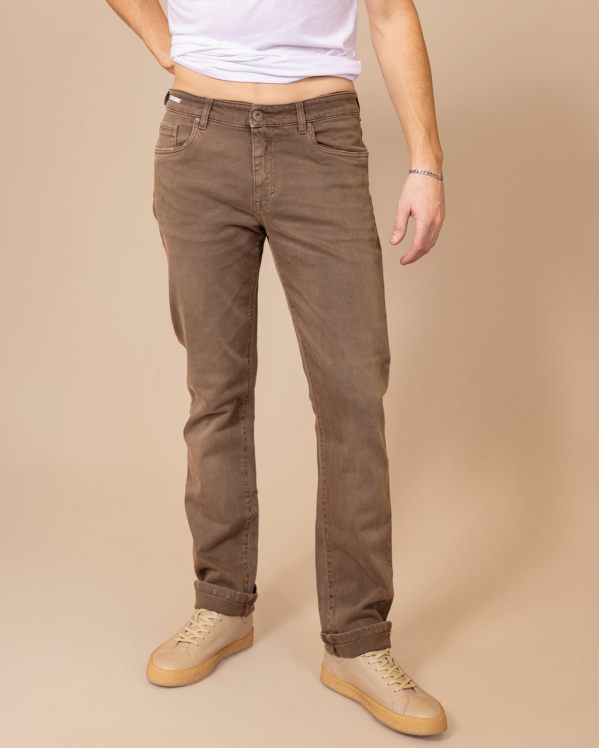 HYDE Cobra HBE Stretch Pant in Liquirizia cotton-elastane stretch twill, front view from the waist down on a male model, styled with a white tee and tan sneakers
