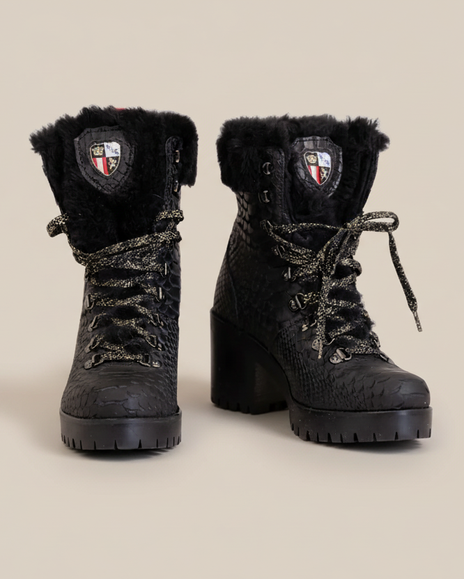 Black lace-up boots with fur trim on a white background