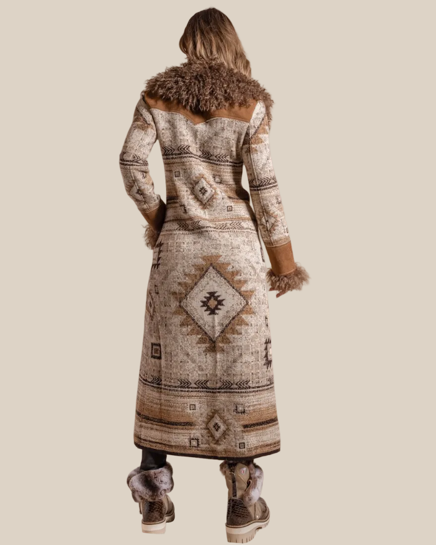 Person wearing a long patterned coat with fur trim on a beige background