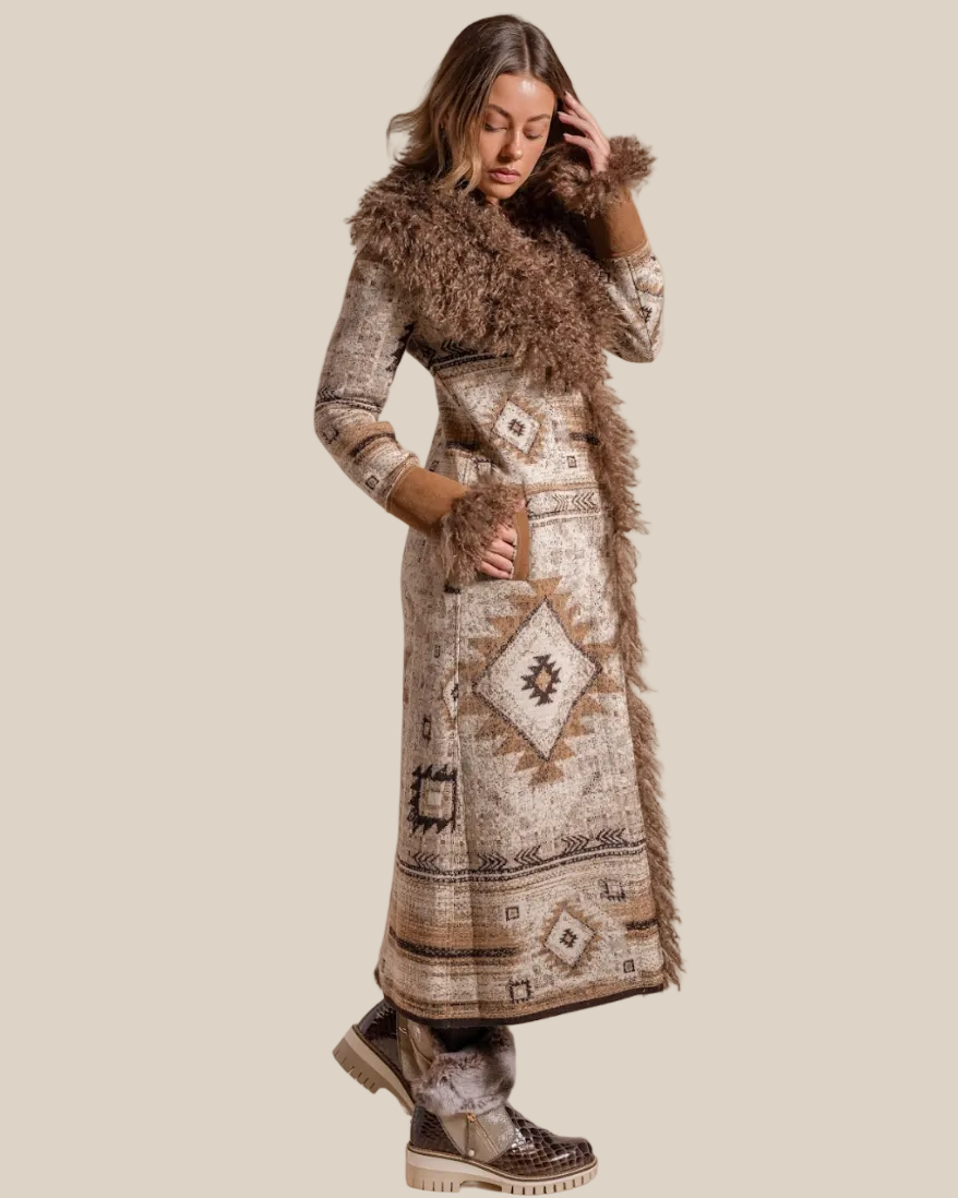 Woman wearing a long, patterned coat with fur trim on a beige background