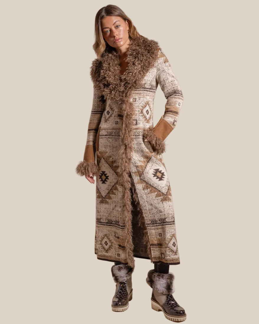 Woman wearing a long patterned coat with fur trim on a beige background