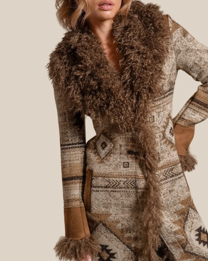 Person wearing a patterned coat with fur collar and cuffs on a beige background