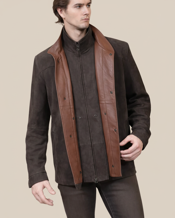 Man wearing a brown jacket with leather accents on a beige background