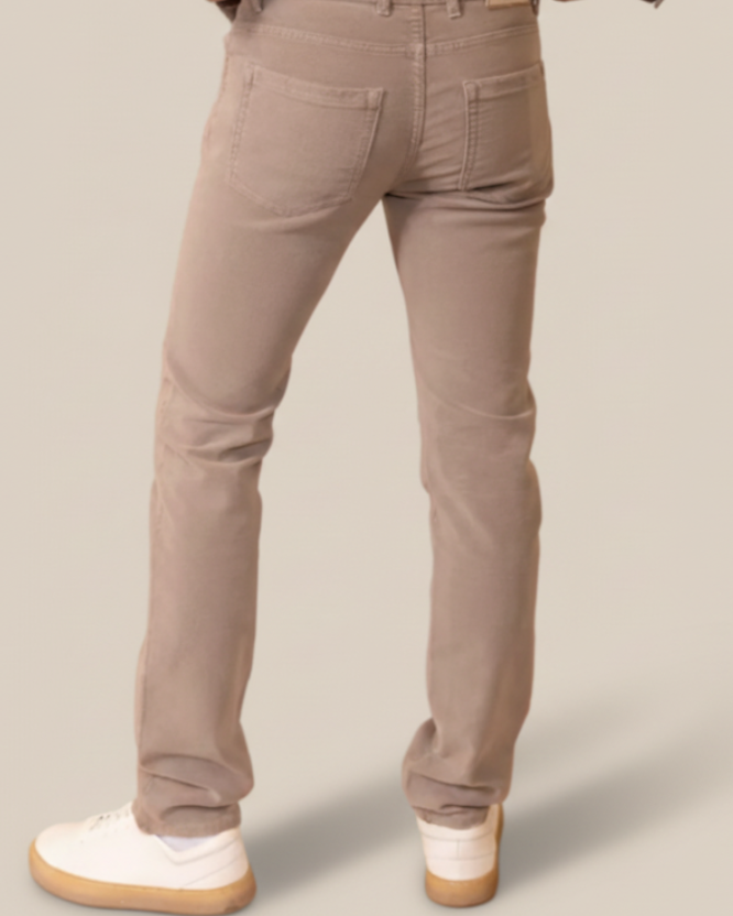 Person wearing brown pants and a gray jacket on a beige background