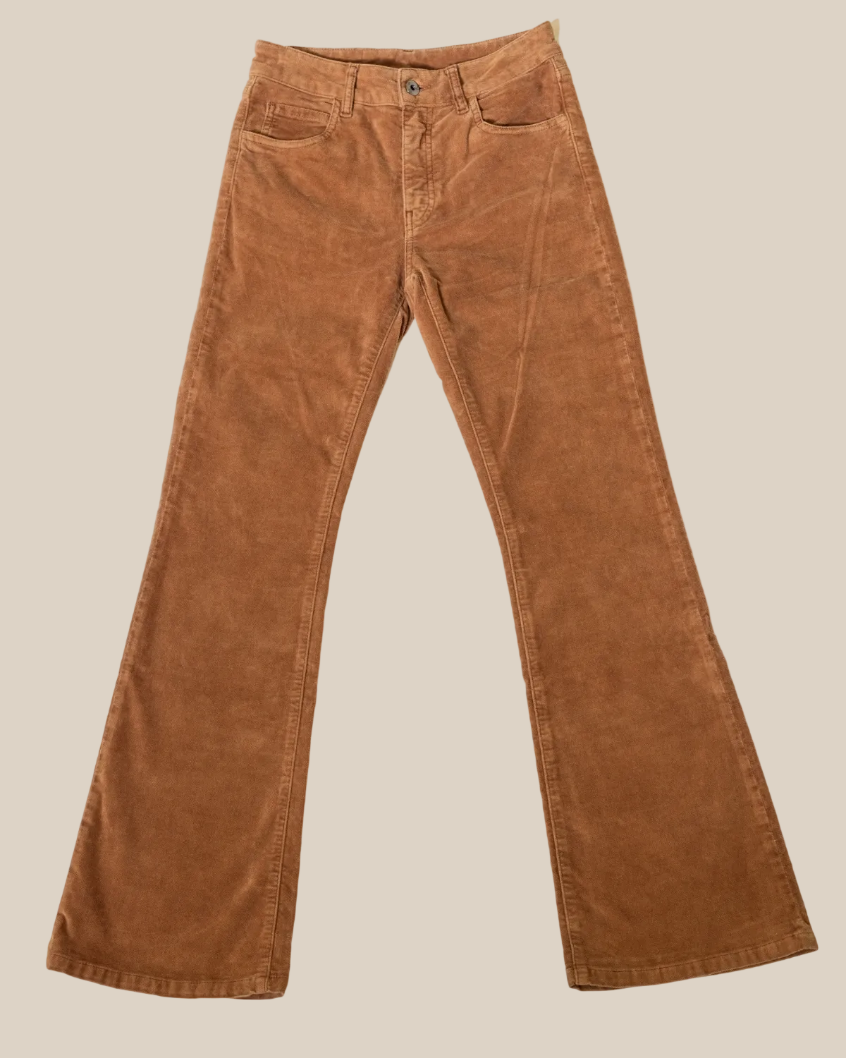 Brown moleskin pants on a beige background