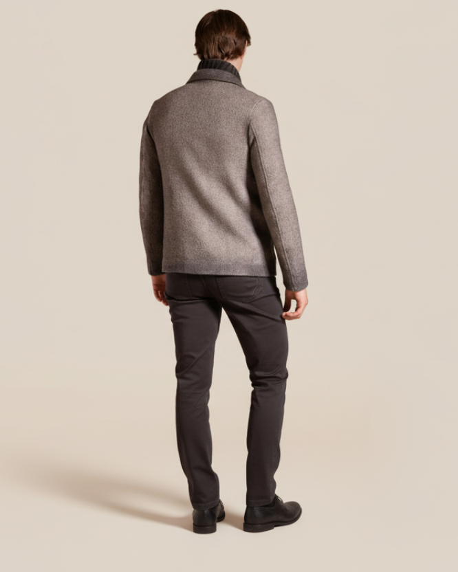Man wearing a gray textured jacket on a beige background