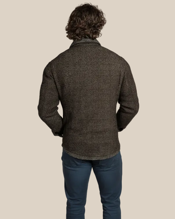 Man wearing a dark brown textured jacket on a beige background