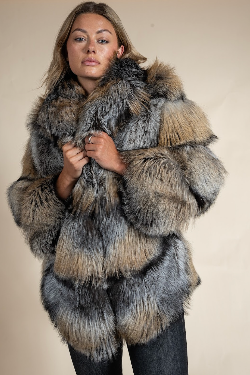 Person wearing a fur coat with a neutral background