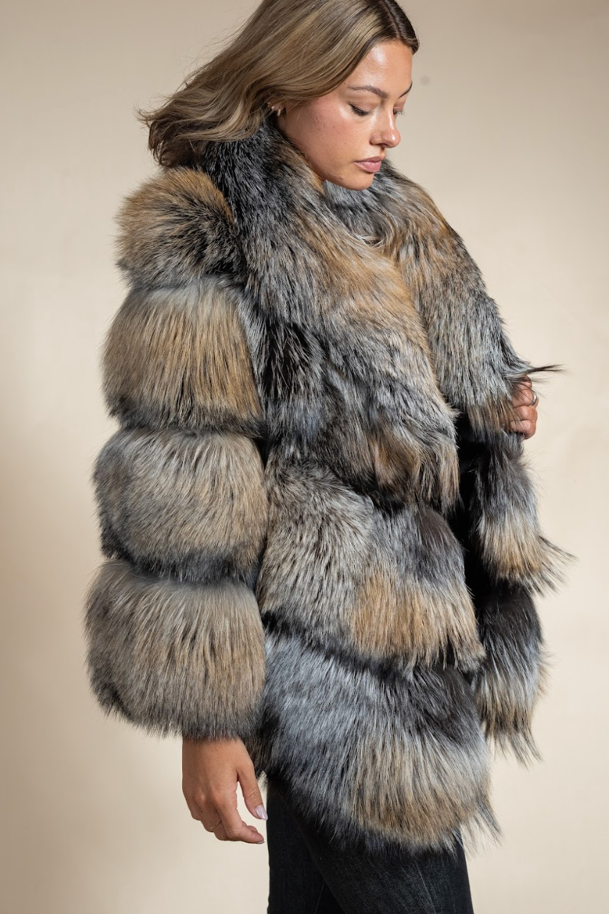 Woman wearing a fur coat with a neutral background