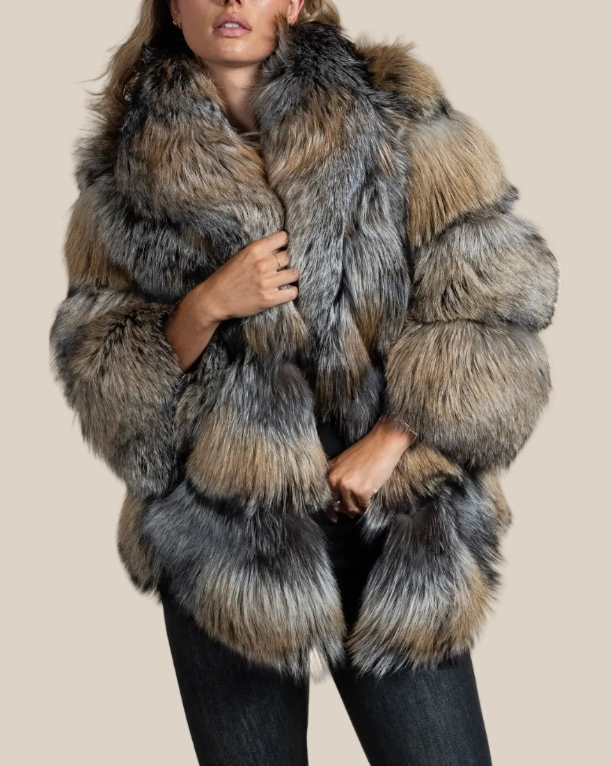 Person wearing a fur coat with a neutral background