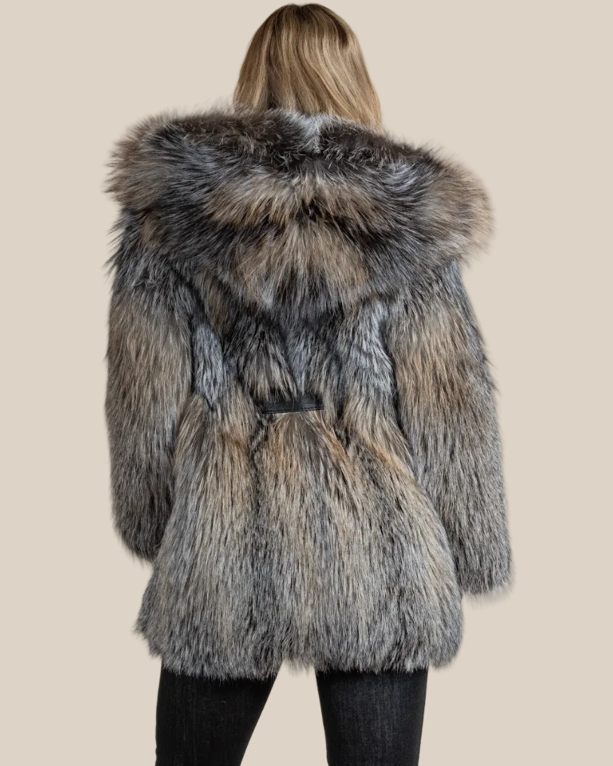 Person wearing a fur coat with a neutral background