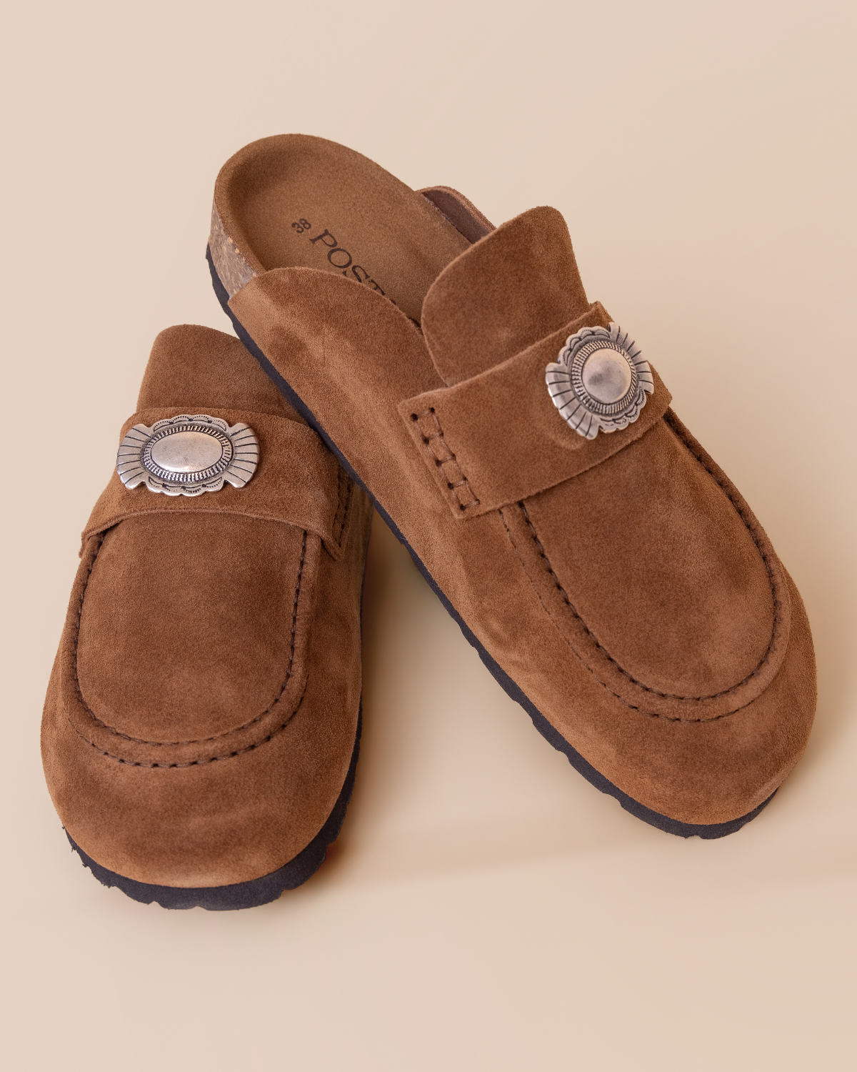 close-up — concho detail and hand-stitched construction