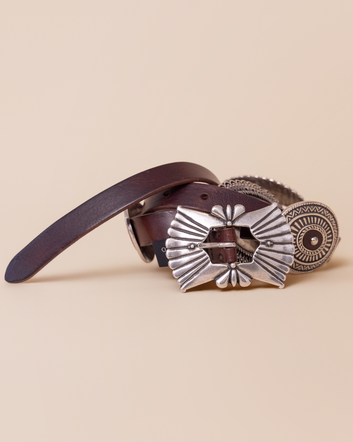 full view — engraved concho medallions and antiqued buckle
