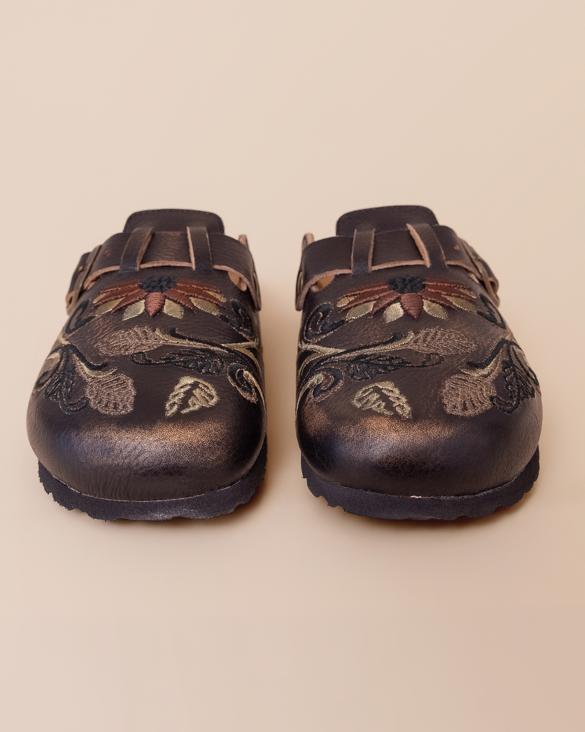 front view — embroidered floral and scroll motifs on cammello leather