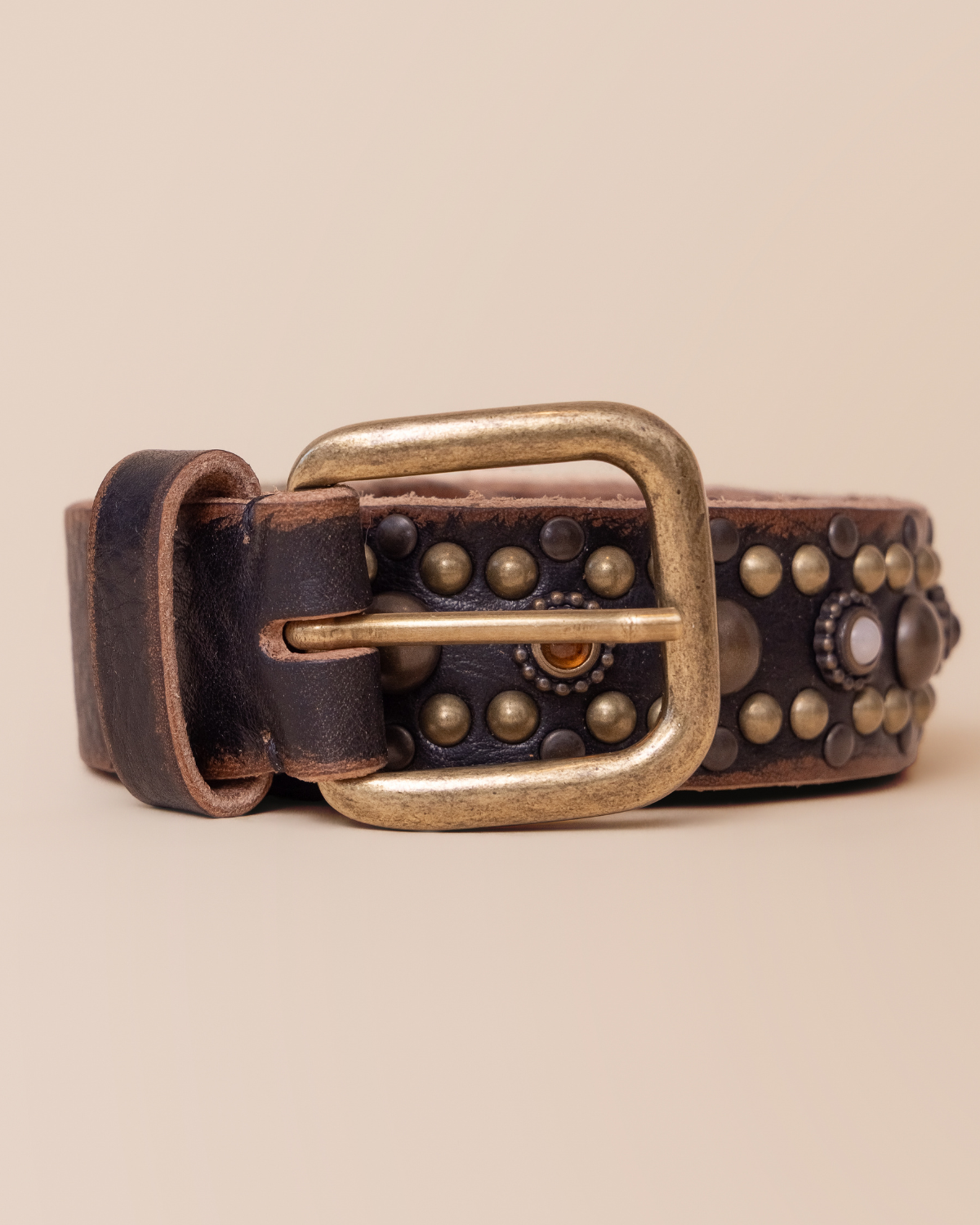 close-up — studs in varied sizes and antiqued finishes