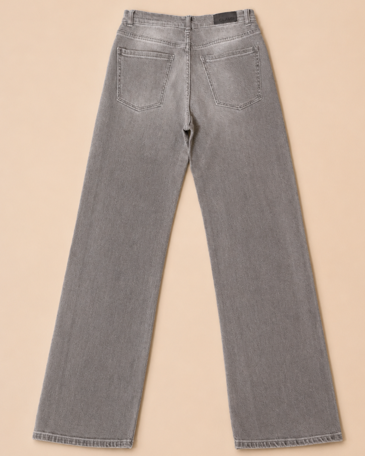 Gray jeans on a beige background