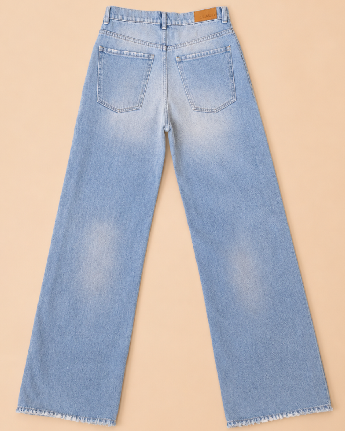 Light blue jeans on a beige background
