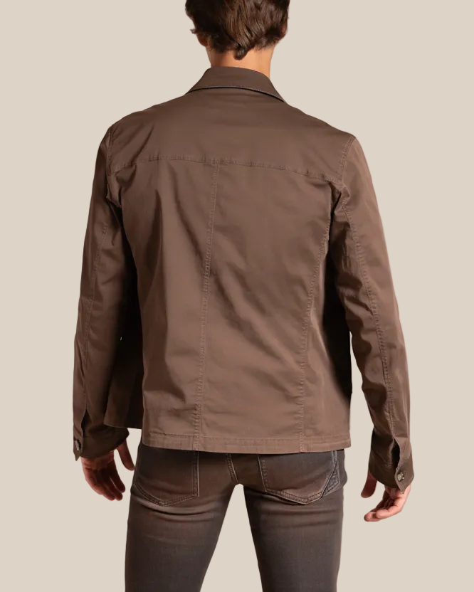 Brown jacket worn by a person on a beige background