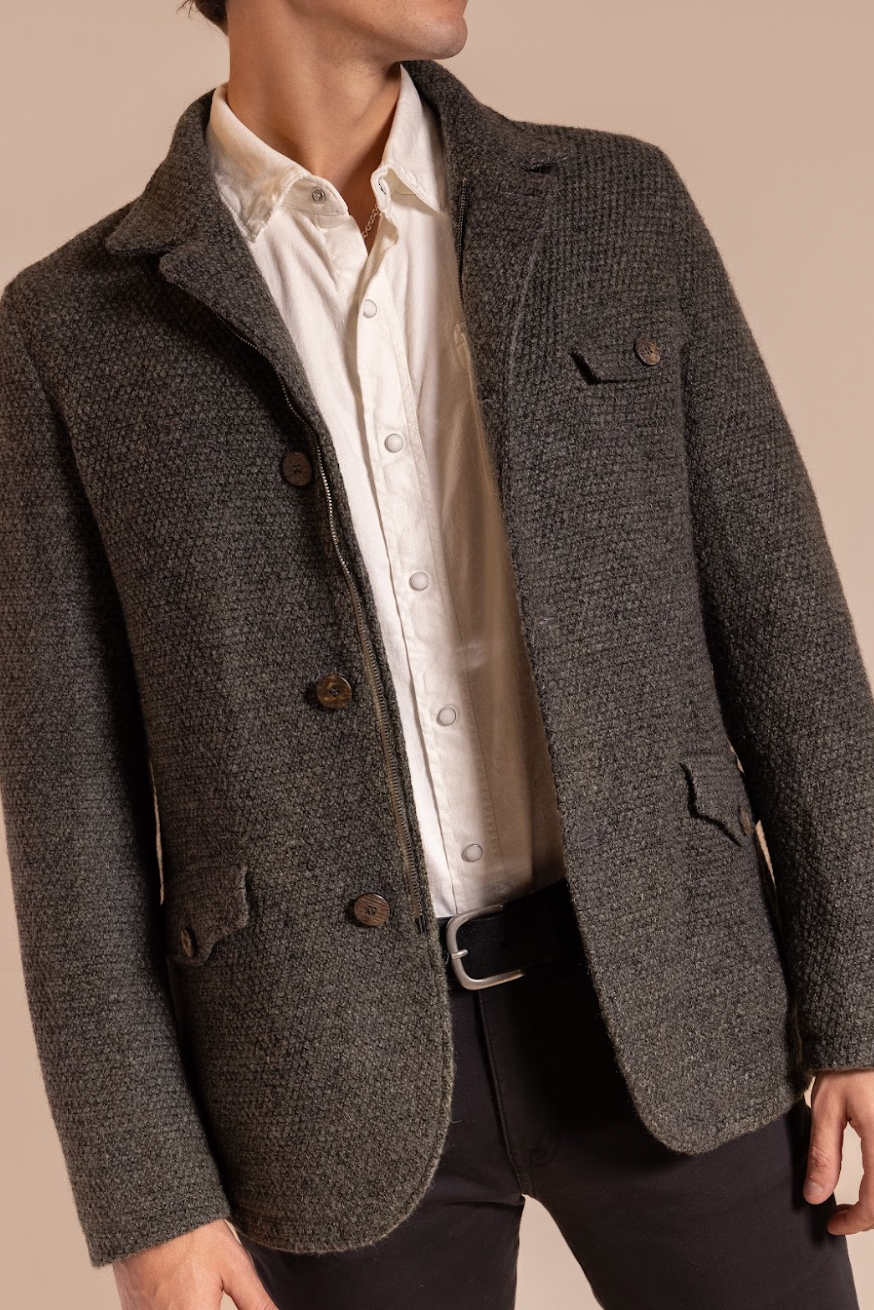 Gray textured blazer over a white shirt on a neutral background