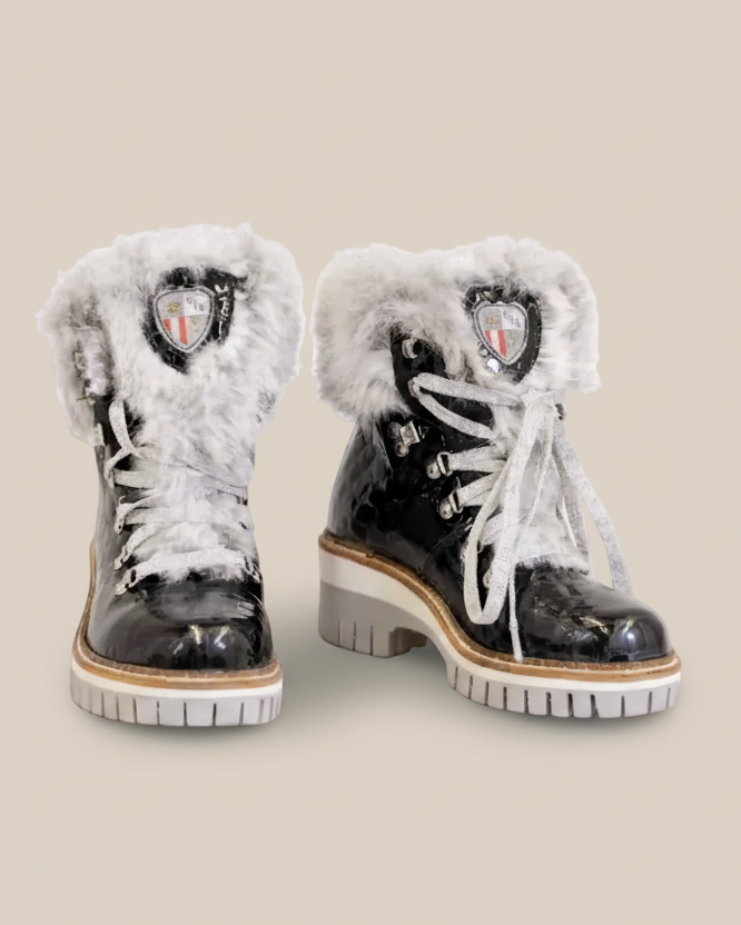 Pair of black winter boots with white fur trim on a white background