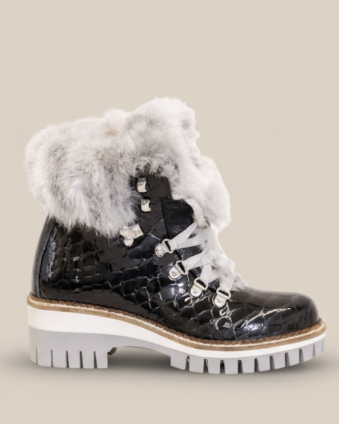 Black winter boot with fur trim on a white background