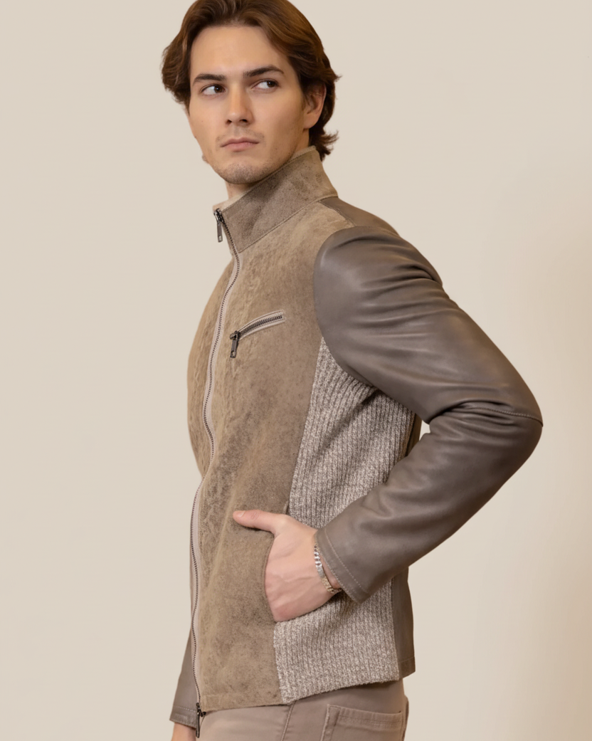 Man wearing a brown and gray jacket against a beige background