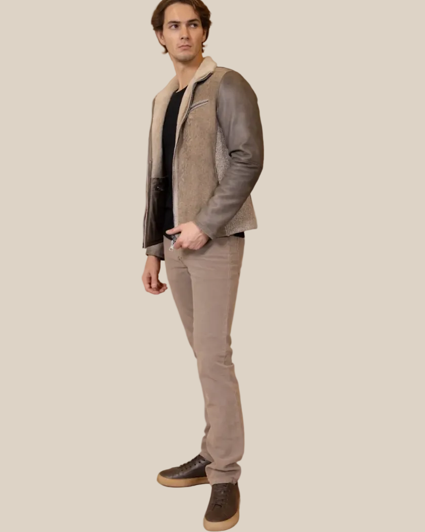 Man wearing a gray shearling leather jacket hood on a light background