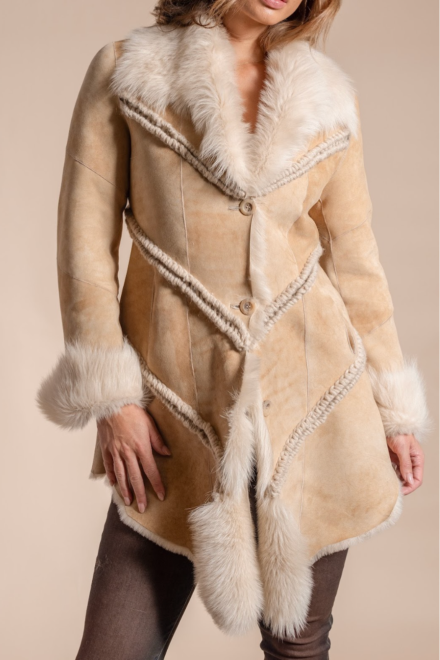 Beige shearling coat with white fur trim on a beige background