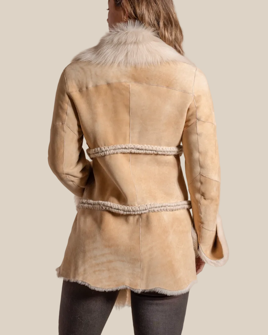 Beige shearling coat with fur collar on a beige background