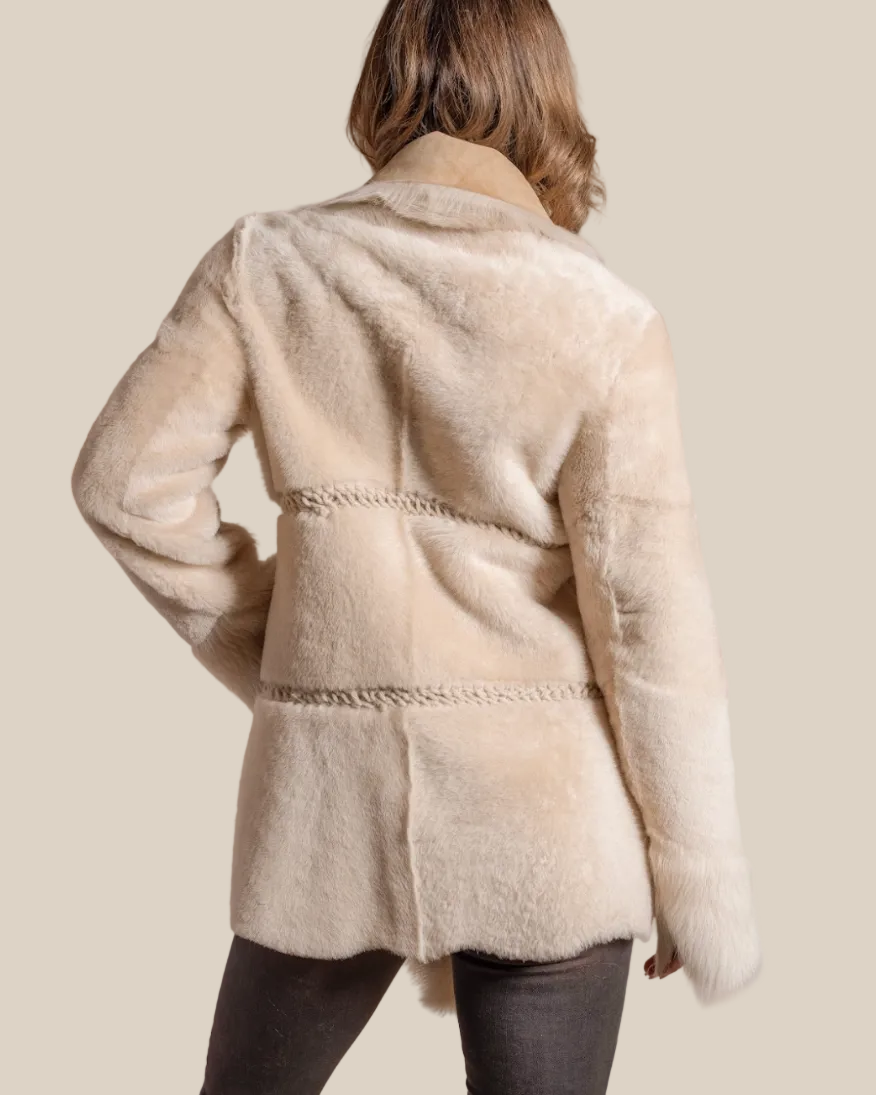 Beige coat worn by a person on a beige background