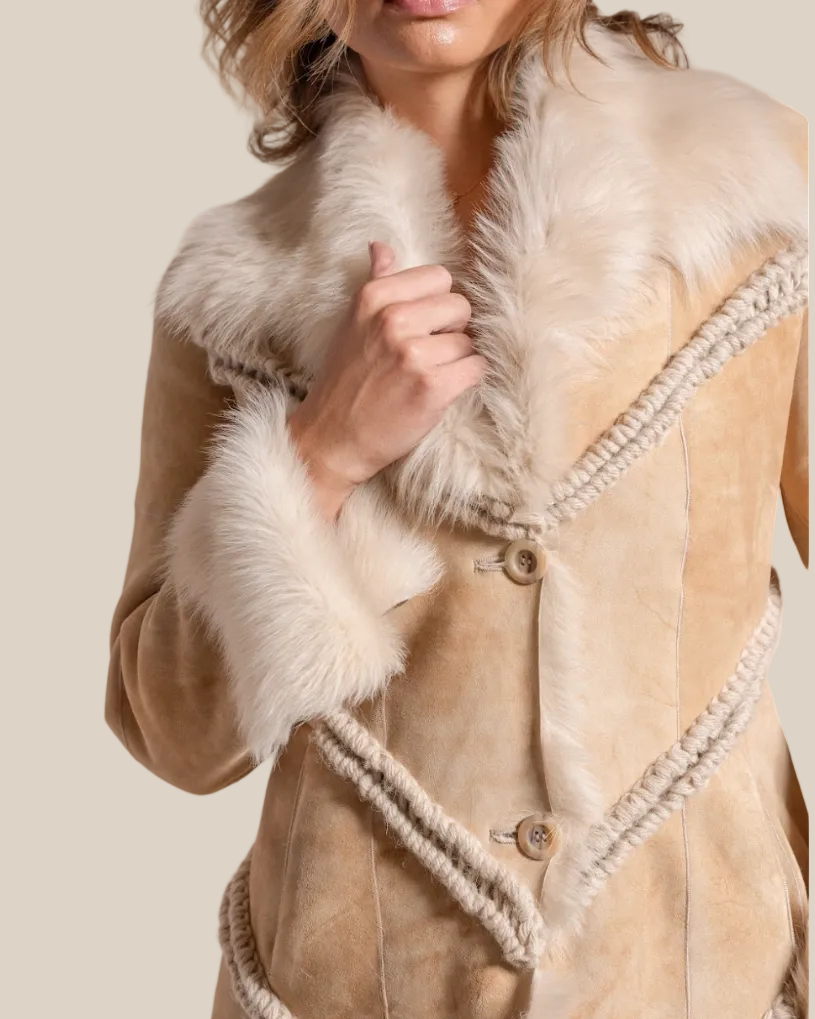 Close-up of a beige coat with white fur trim on a neutral background