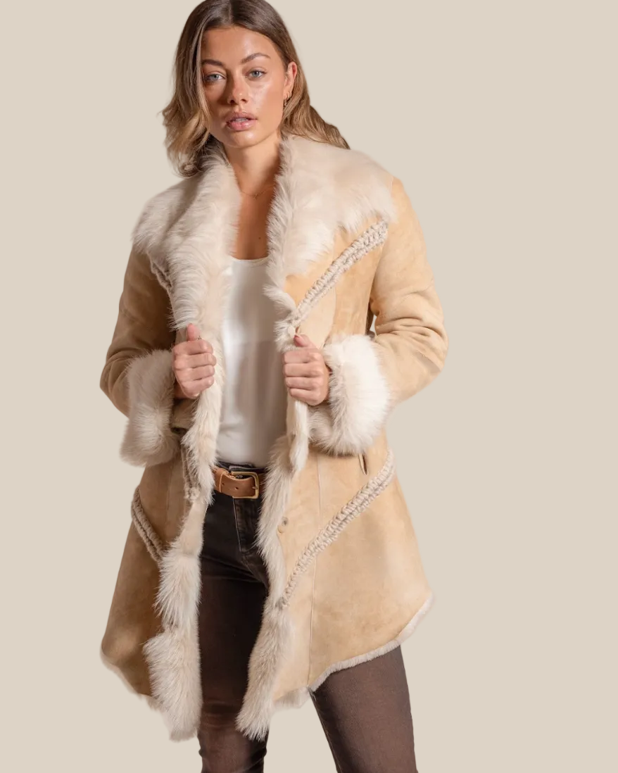 Woman wearing a beige coat with fur trim on a beige background