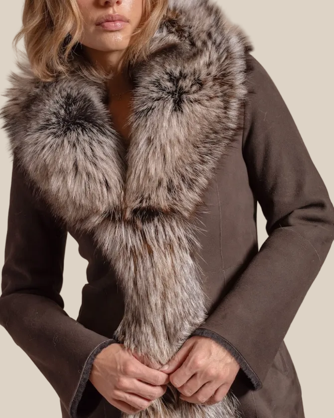 Brown coat with a fur scarf against a beige background