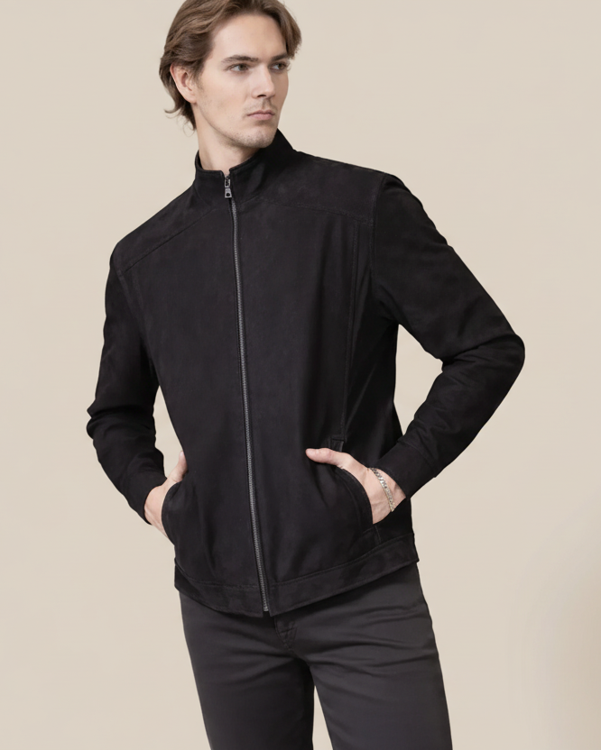 Man wearing a black jacket on a beige background