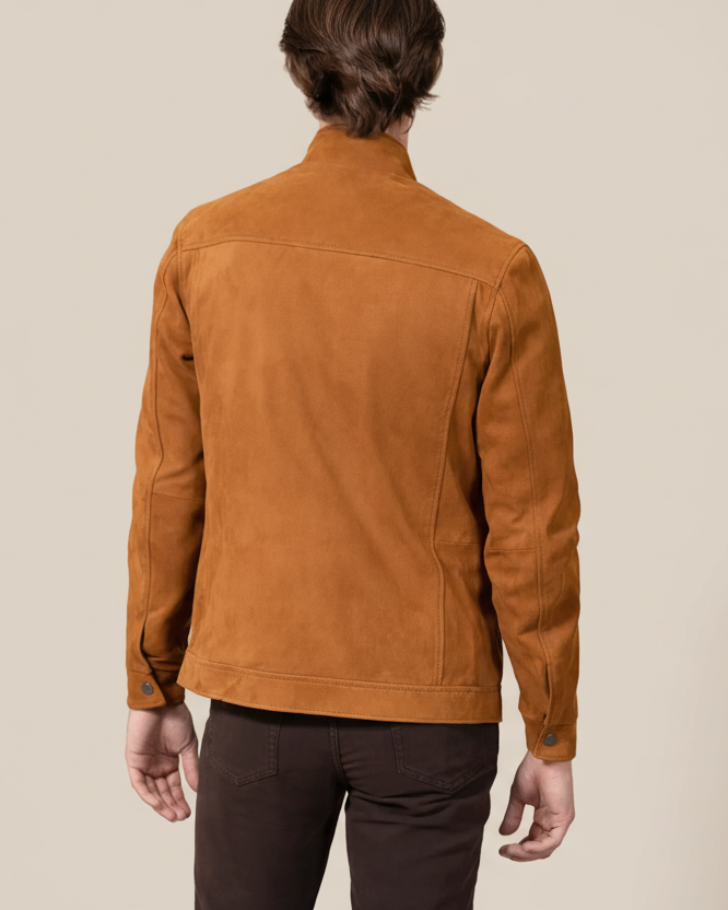 Person wearing a brown suede jacket on a beige background