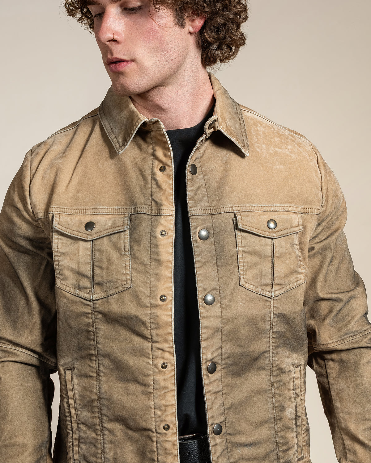 Close-up detail of the HYDE Sawyer Jacket's overdyed cotton blend in Desert, showing the hand-sandblasted texture and tonal topstitching.
