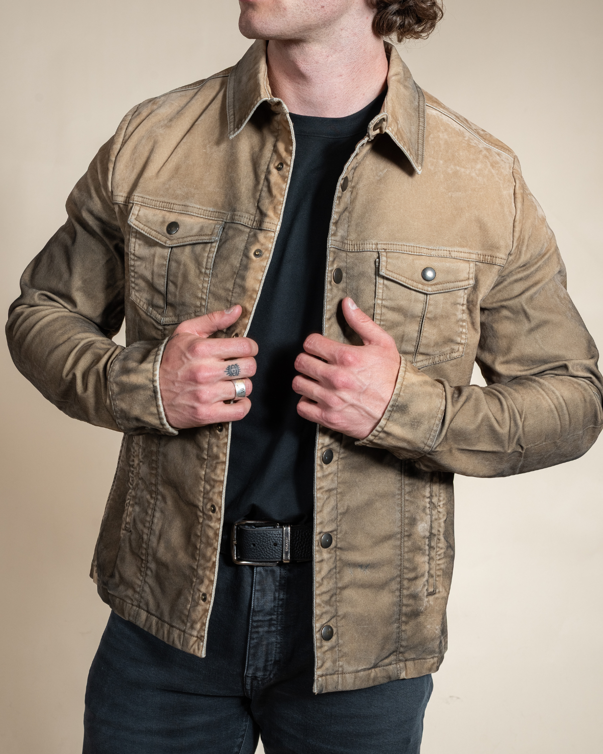 HYDE Sawyer moleskin trucker jacket in desert — front detail of brushed brass buttons, double chest pockets and slash pockets, worn open over a tee