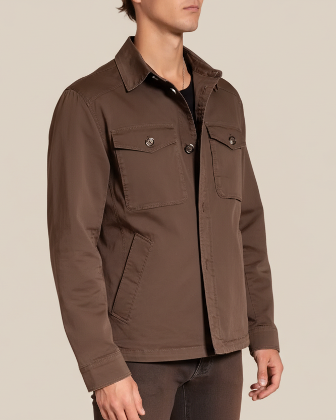 Man wearing a brown jacket on a beige background