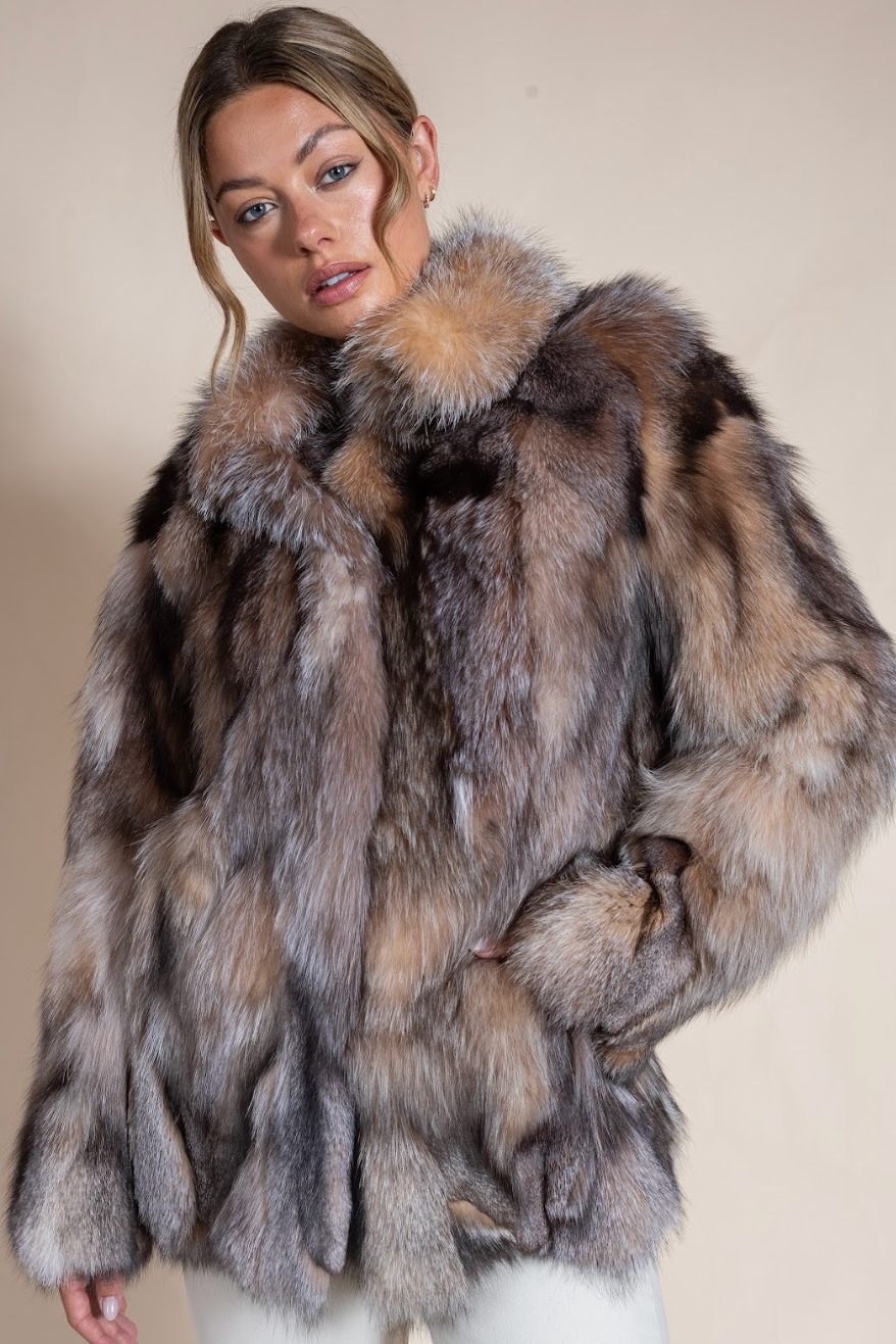 Woman wearing a fur coat with a neutral background