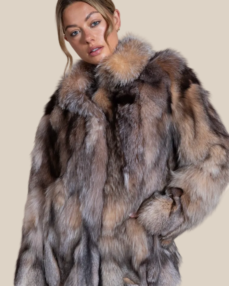 Woman wearing a fur coat with a neutral background