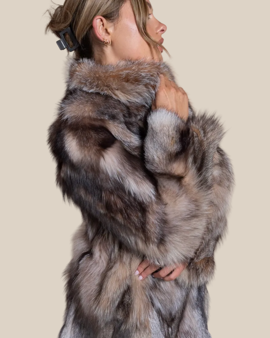 Person wearing a fur coat with a neutral background