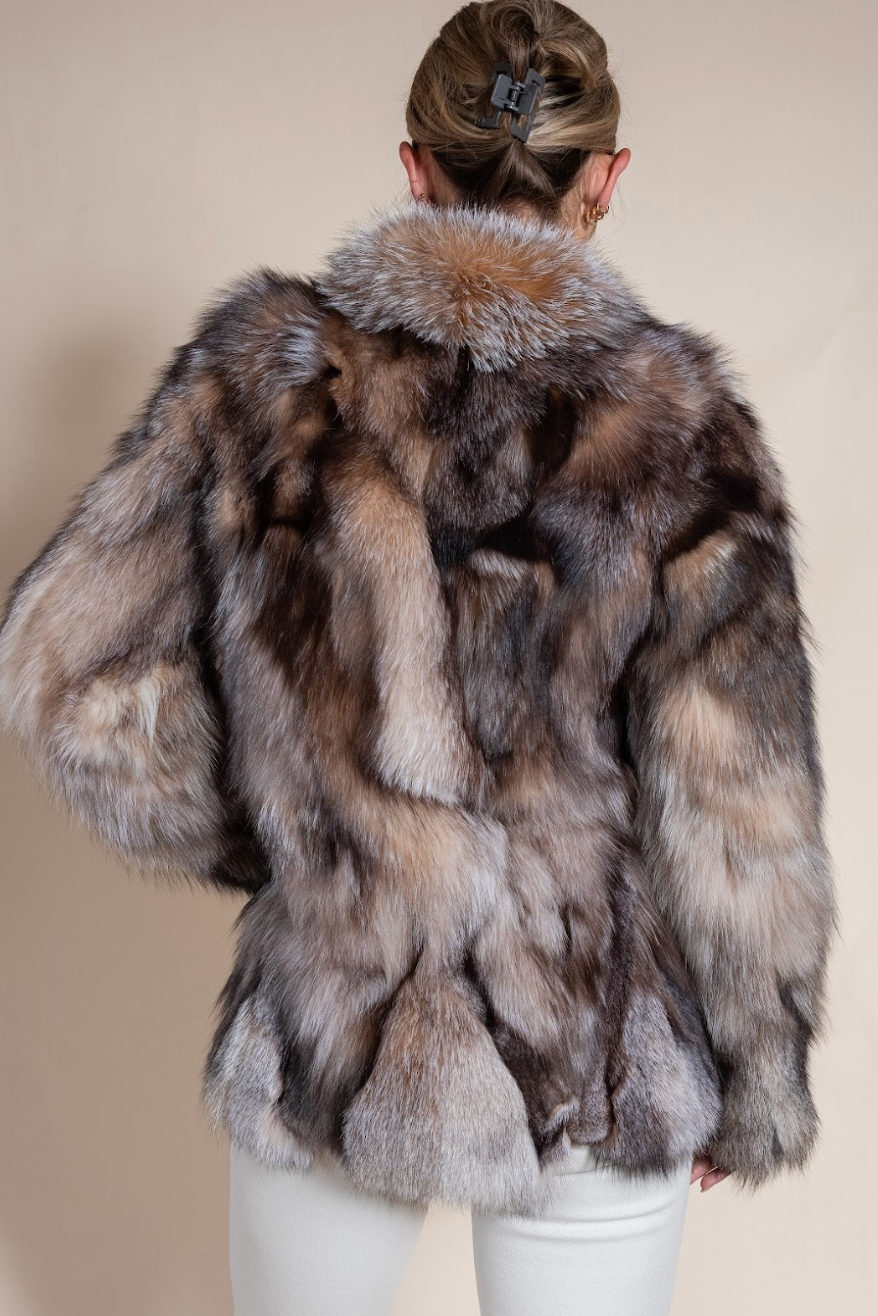 Person wearing a fur coat with a neutral background