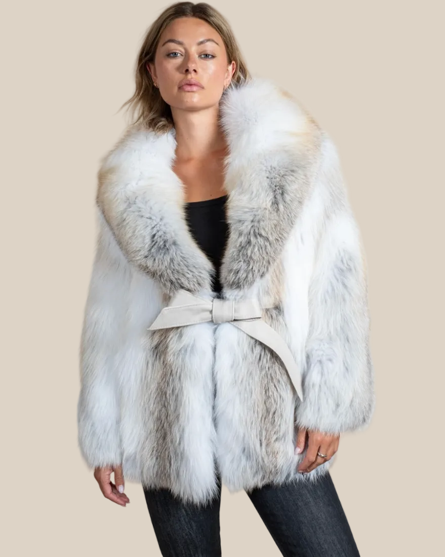 Woman wearing a white fur coat with a belt on a beige background