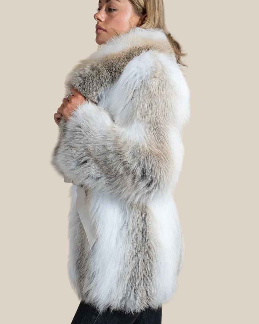 Woman wearing a fur vest with a neutral background