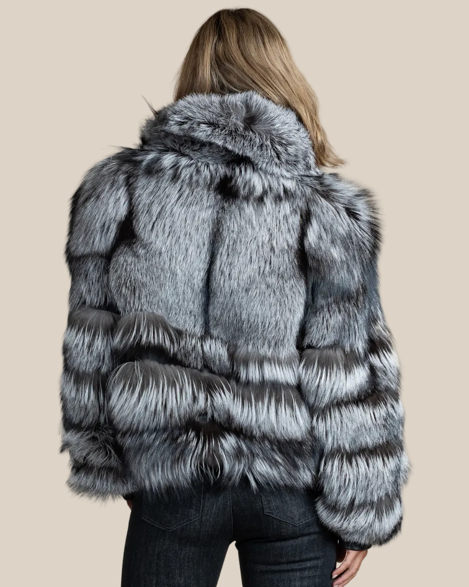 Person wearing a gray fur coat on a beige background