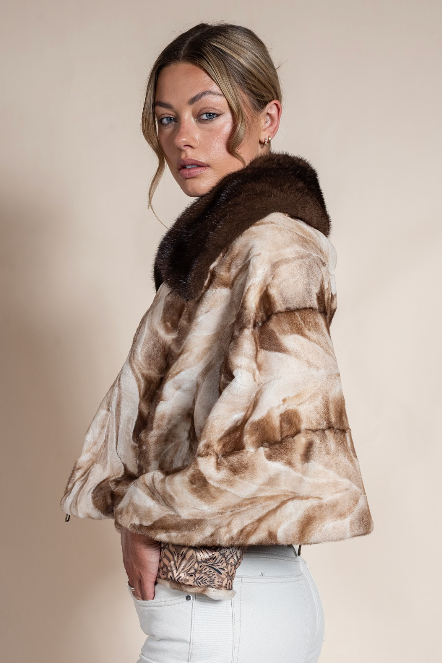 Woman wearing a fur coat with a neutral background