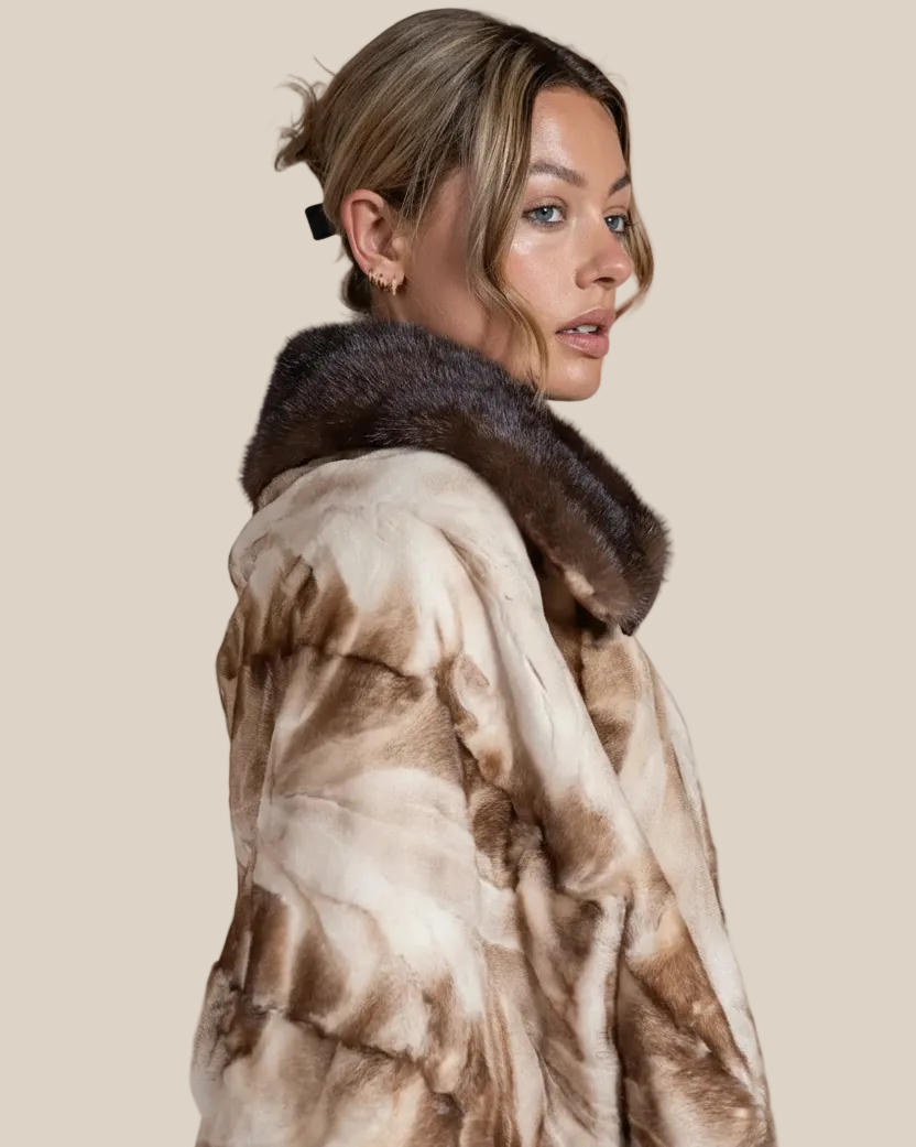 Woman wearing a fur coat with a neutral background