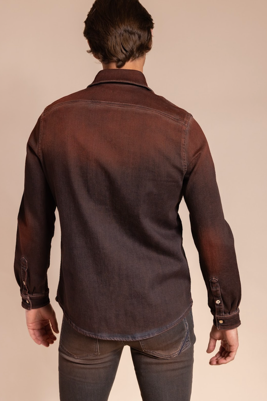 Man wearing a brown denim shirt against a beige background