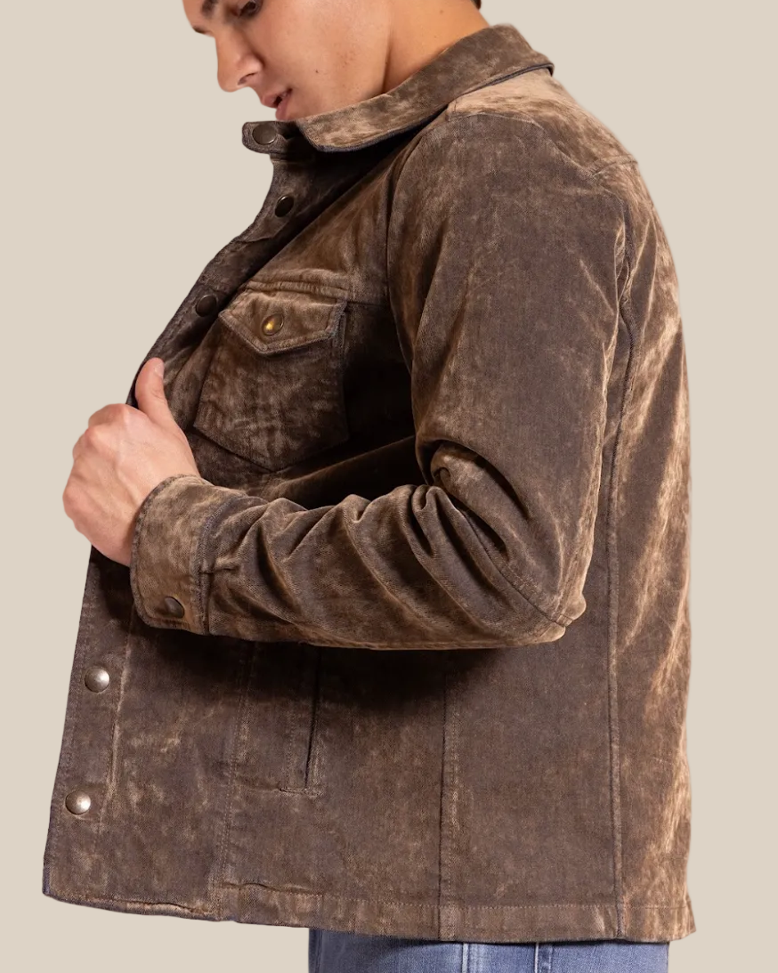 Man wearing a brown distressed jacket against a beige background