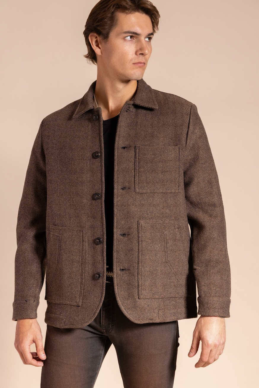 Man wearing a brown jacket on a beige background